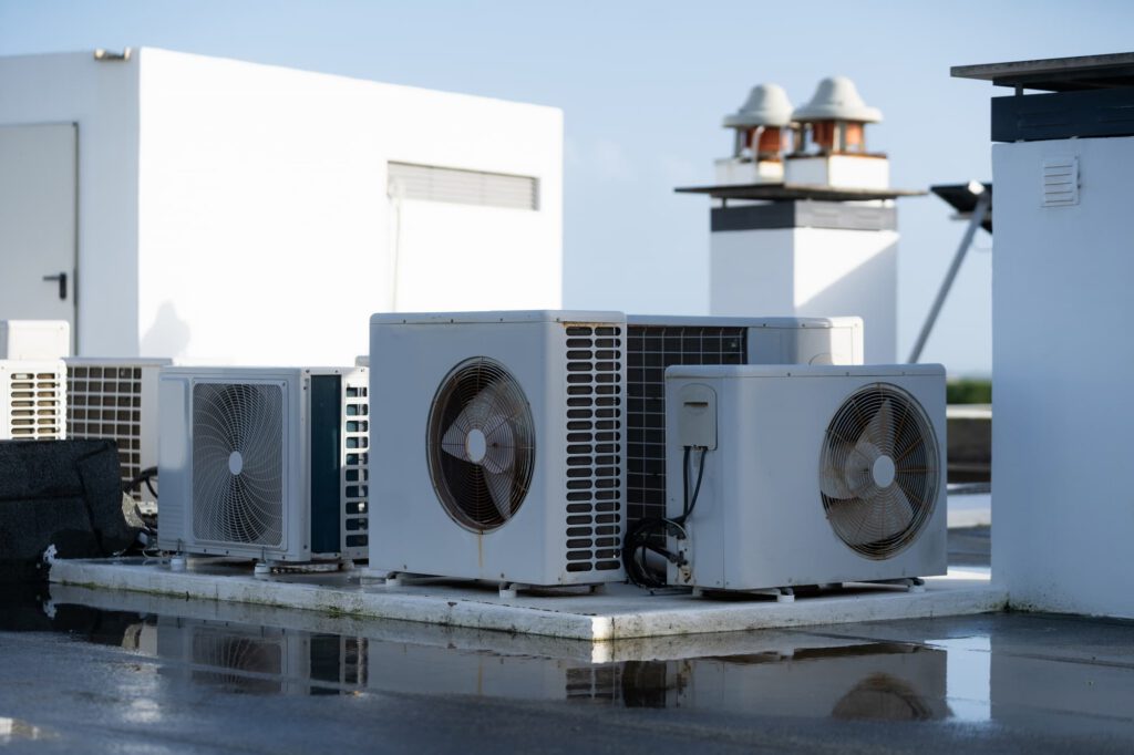 Commercial rooftop air conditioning condenser units installed on a flat roof.
