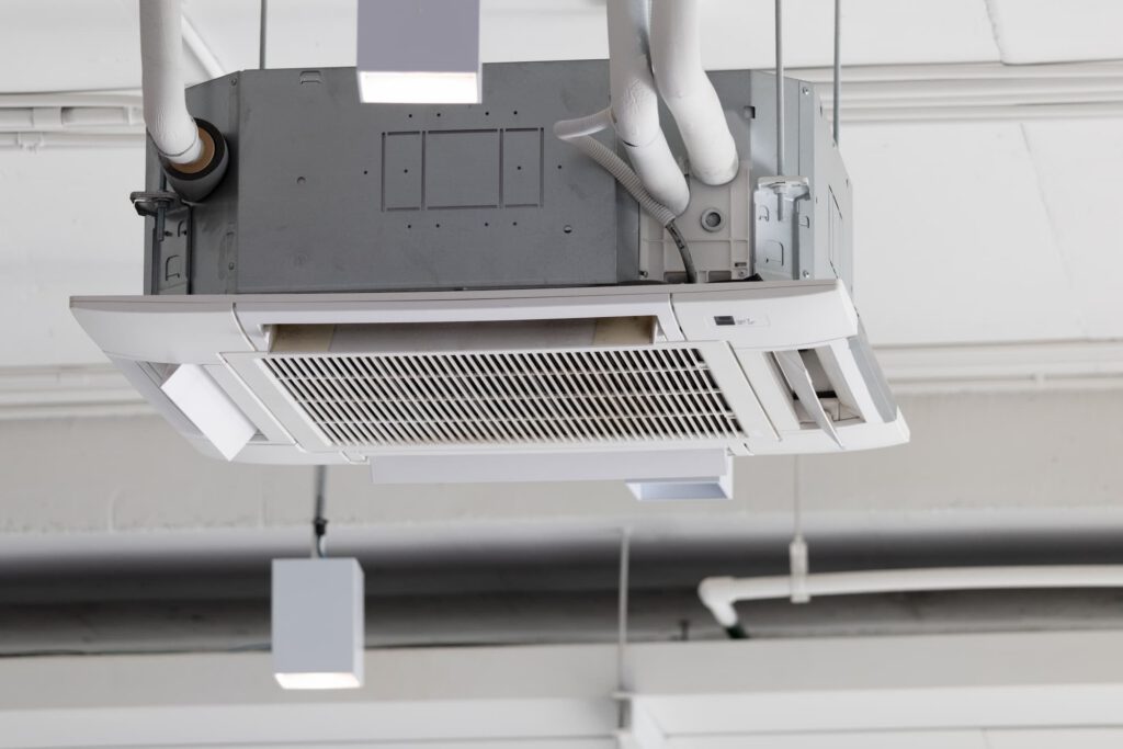 Ceiling cassette air conditioning unit installed in a commercial office ceiling.