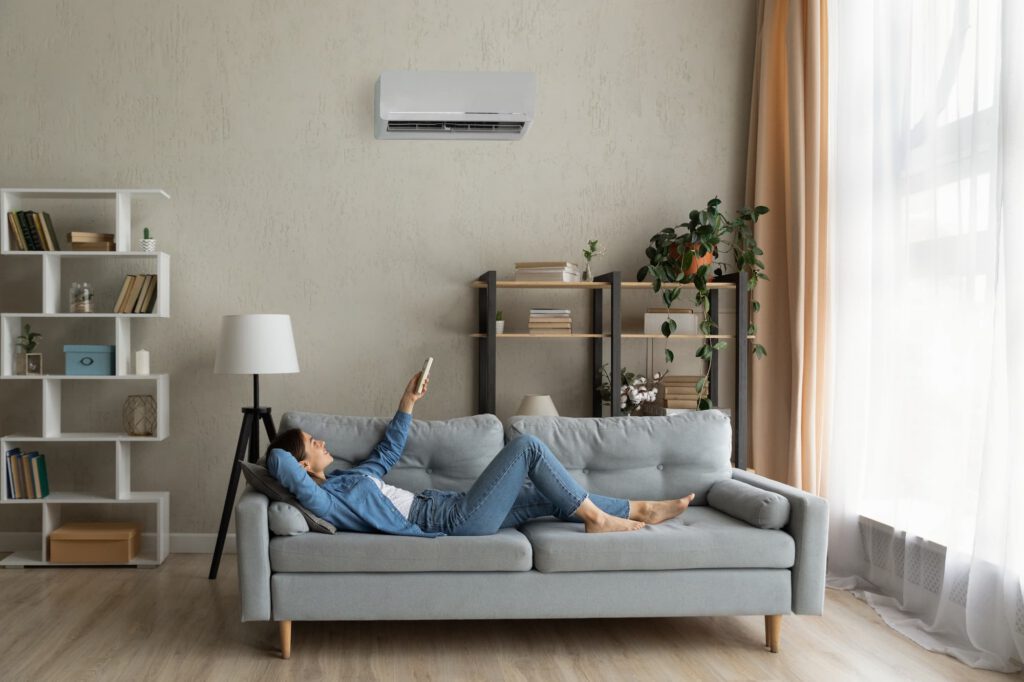 Modern living room with a wall-mounted air conditioning unit keeping the home cool and comfortable.